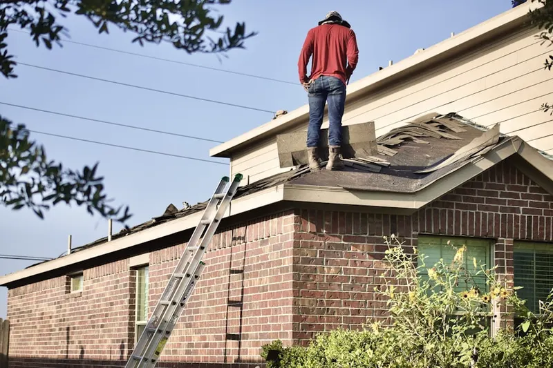 Professional roofer working on a residential roof in Greenhills